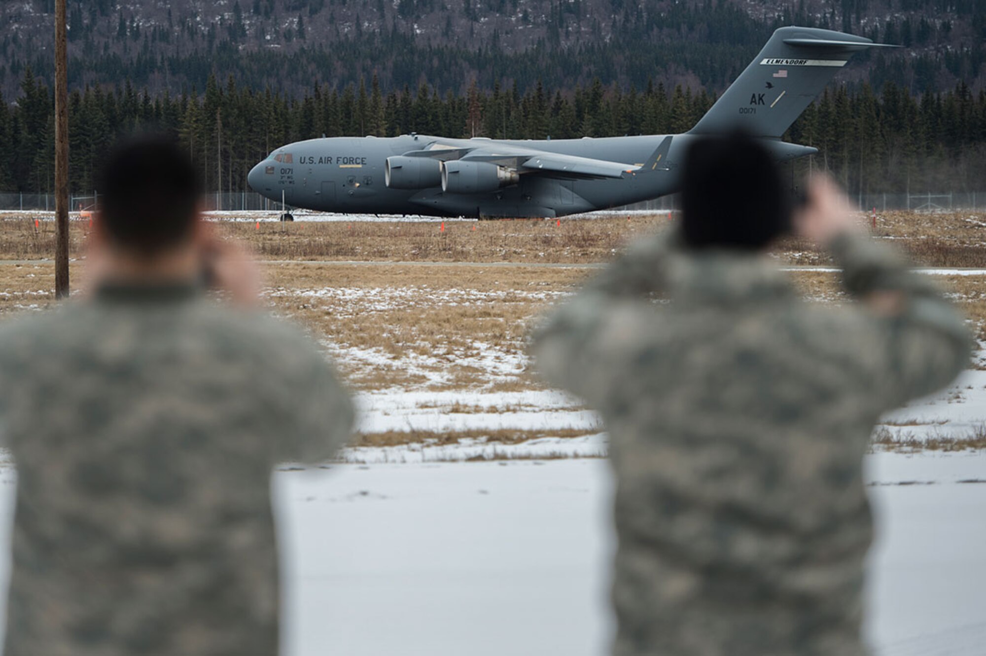 A U.S. Air Force C-17 Globemaster III from the 517th Airlift Squadron takes off from Bryant Army Air Field on Joint Base Elmendorf-Richardson, Alaska, as Army Soldiers watch, March 7, 2016.  The event marked the first time a C-17 has taken off from the airfield since its construction in 1958, when the runway was built by the U.S. Army on then-separate Ft. Richardson to support Soldiers in remote areas of Alaska. (U.S. Air Force photo by Senior Airman James Richardson)
