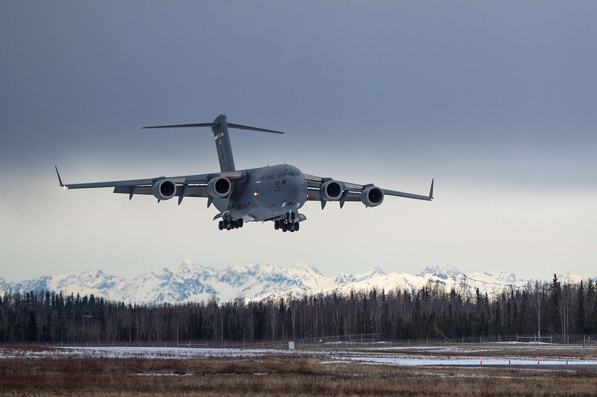 A U.S. Air Force C-17 Globemaster III from the 517th Airlift Squadron lands at Bryant Army Air Field on Joint Base Elmendorf-Richardson, Alaska,  March 7, 2016.  The event marked the first time a C-17 has taken off from the airfield since its construction in 1958, when the runway was built by the U.S. Army on then-separate Ft. Richardson to support Soldiers in remote areas of Alaska. (U.S. Air Force photo by Senior Airman James Richardson)