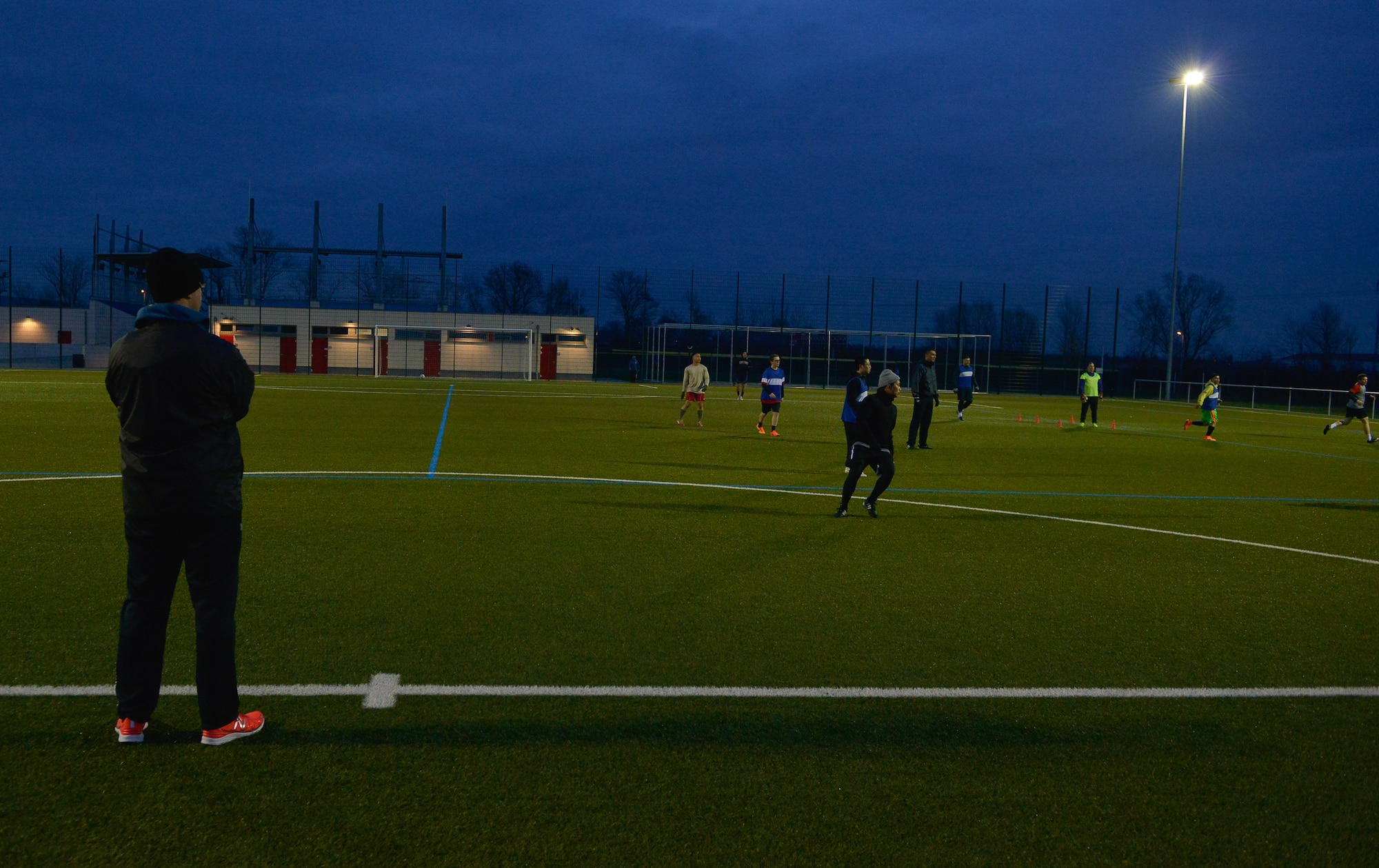 First Lt. Sean Miller, 7th Weather Squadron chief of education and training, watches his soccer team as they begin a practice session Mar. 3, 2016, at U.S. Army Garrison Wiesbaden, Germany. To assess what areas his team’s strengths and weaknesses are, Miller pits his players on opposite teams and plays them against each other to depict an actual game. (U.S. Air force photo/Airman 1st Class Lane T. Plummer)