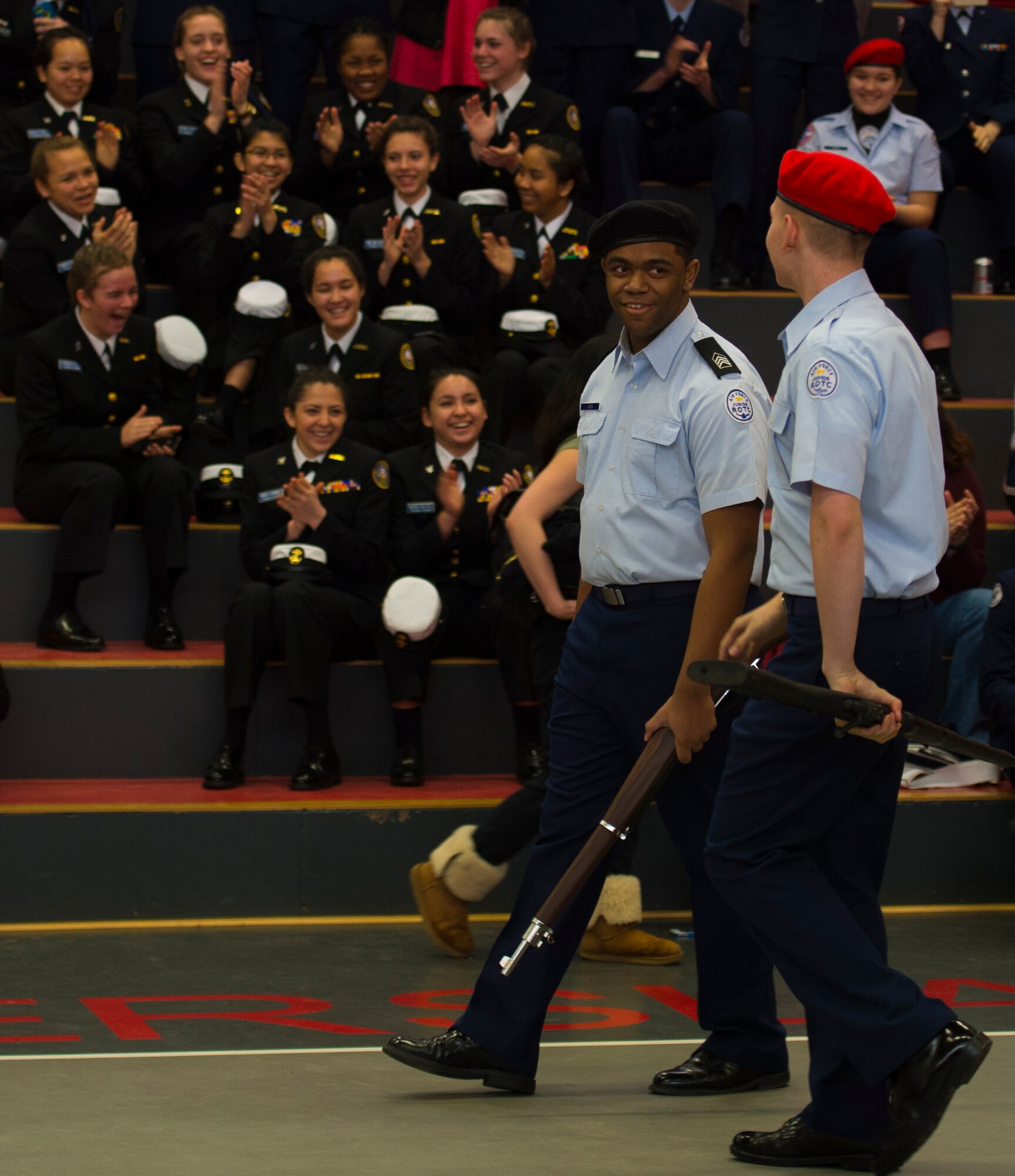 The crowd cheers after watching the Kaiserslautern junior ROTC drill team complete their performance during the annual Department of Defense Education Activity Europe drill team championship held on Vogelweh, Germany, March 5, 2016. Approximately 100 cadets from 11 junior ROTC from across Europe gathered at Kaiserslautern High School to compete in the annual event. (U.S. Air Force photo Senior Airman Jonathan Stefanko) 