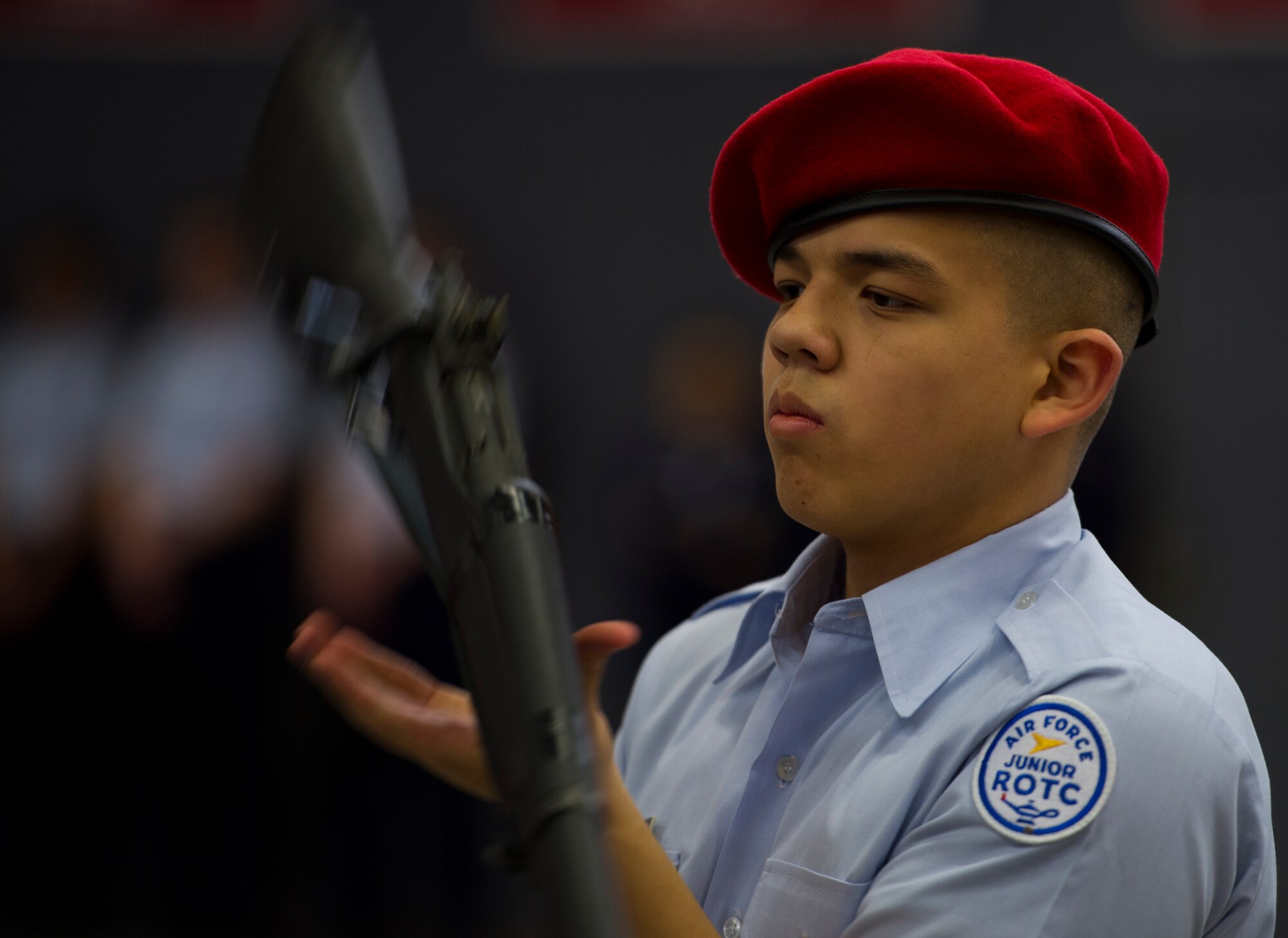 Anthonee Kryznowek, Kaiserslautern High School junior ROTC cadet, spins a rifle during the annual Department of Defense Education Activity Europe drill team championship held on Vogelweh, Germany, March 5, 2016. Approximately 100 Air Force and Navy junior ROTC teams from across Europe gathered at Kaiserslautern High School to compete in the annual event. (U.S. Air Force photo Senior Airman Jonathan Stefanko))