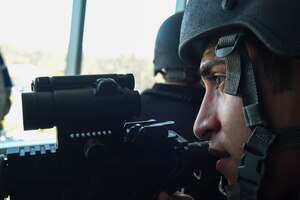 Senior Airman Marco Rodriguez, 11th Security Forces Squadron Emergency Services Team operator, stands watch while a room is cleared behind him during an active shooter exercise on Joint Base Andrews, Md., March 9, 2016. EST operators conduct team training twice a month, and base exercises once a quarter, to maintain proficiency. (U.S. Air Force photo by Senior Airman Mariah Haddenham/Released)