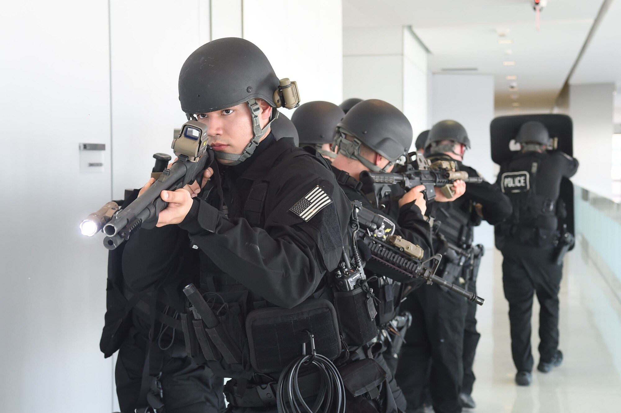 Senior Airman Eddie Jaimes, 11th Security Forces Squadron Emergency Services Team operator, performs rear security with an M-870 shotgun during an active shooter exercise on Joint Base Andrews, Md., March 9, 2016. These exercises utilize dynamic interactive scenarios to evaluate proficiency in individual and team responses.( (U.S. Air Force photo by Senior Airman Mariah Haddenham/Released)