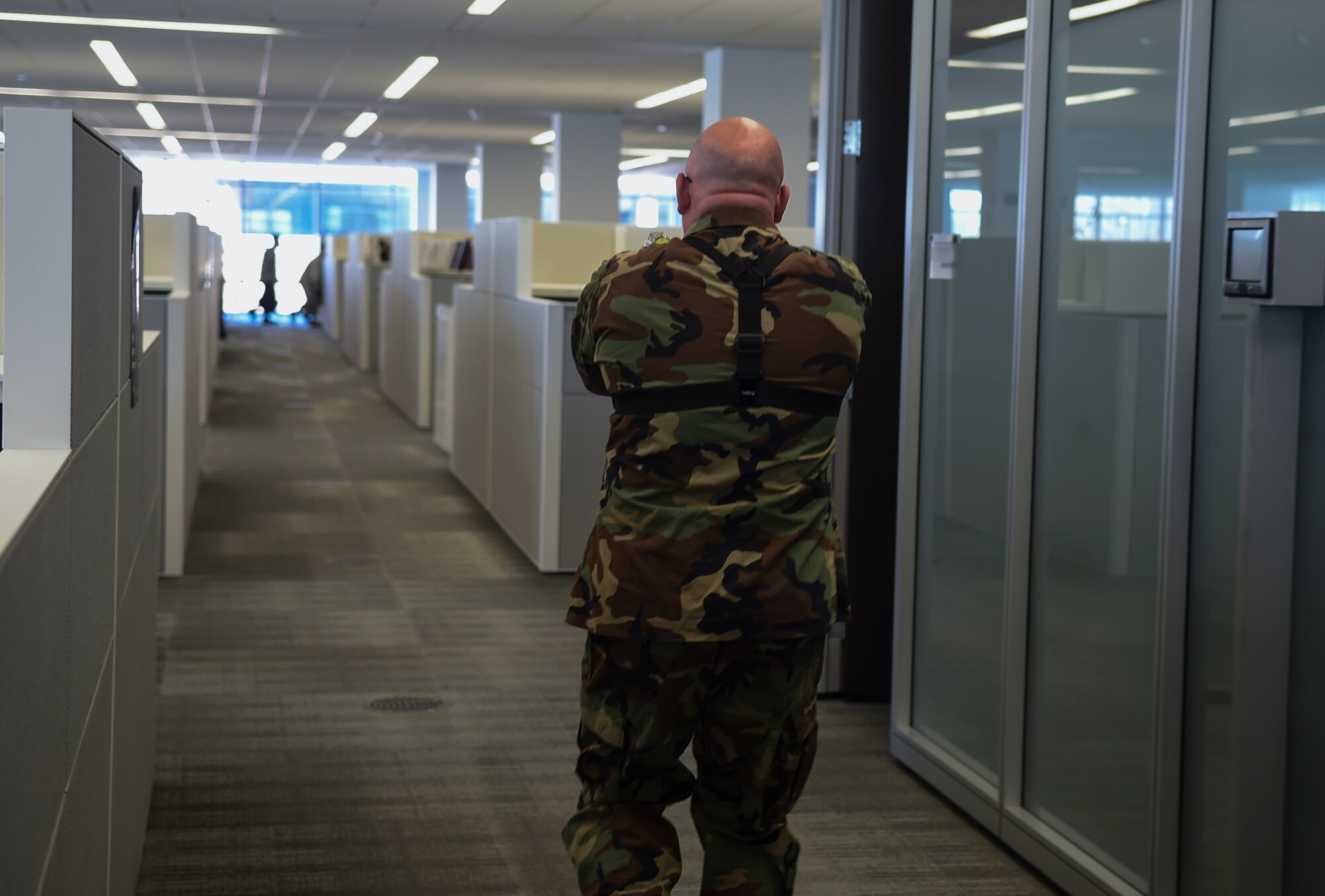 Senior Master Sgt. Guy Yesse, Air National Guard Inspector General's Office air inspections division superintendent, simulates an active shooter during an exercise on Joint Base Andrews, Md., March 9, 2016. Exercise programs utilize dynamic interactive scenarios to evaluate proficiency in individual and team responses.  (U.S. Air Force photo by Senior Airman Mariah Haddenham/Released)