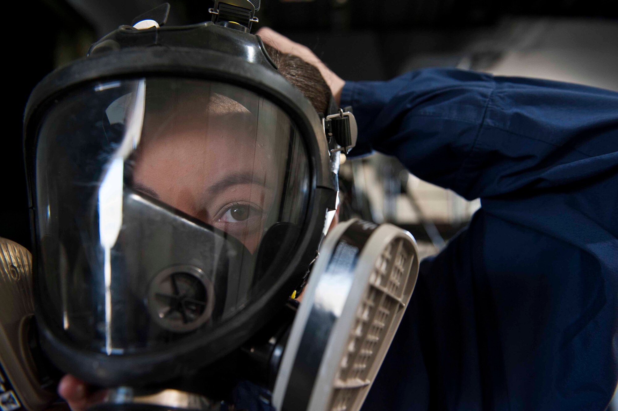 United States Air Force Airman Catherine Wade, 19th Maintenance Squadron aircraft fuels system repair journeyman, tightens her respirator March 4, 2016, at Little Rock Air Force Base, Ark. Respirators are one of the many forms of personal protective equipment required to operate in-tank. (U.S. Air Force photo by Airman 1st Class Mercedes Taylor) 