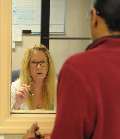 Karen Mallonee, 78th Force Support Squadron Military Personnel Section Customer Support Human Resources technician, assists a customer at the Customer Service Desk.