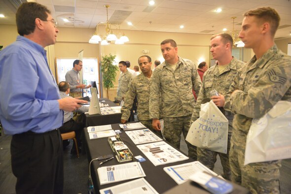 Matthew stricter, a federal sales director for an Austin, Texas firm explains his company’s equipment to members of the 52nd Combat Communications Squadron Wednesday during the 2016 Robins Technology Expo. Straiter’s company was one of more than 20 exhibitors at the Heritage Club providing hands-on demonstrations of various technologies. The free event was hosted by the 402nd Software Maintenance Group. (U.S. Air Force photo by Ray Crayton)

