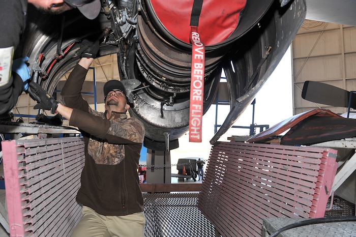 Philip Blackwell, 560th Aircraft Maintenance Squadron sheet metal mechanic, attaches an Air Force Special Operations Command  MC-130H’s clam shell door with the assistance of fellow mechanic Brian Tindall. Returning air power as quickly as possible to the warfighter – that’s the goal of the C-130 Air Force Special Operations Command Acceleration Team at Robins Air Force Base, Ga. These high-demand aircraft are a  direct result of a team effort that once again showcases that Success Here = Success There! (U.S. Air Force photo by Tommie Horton)
