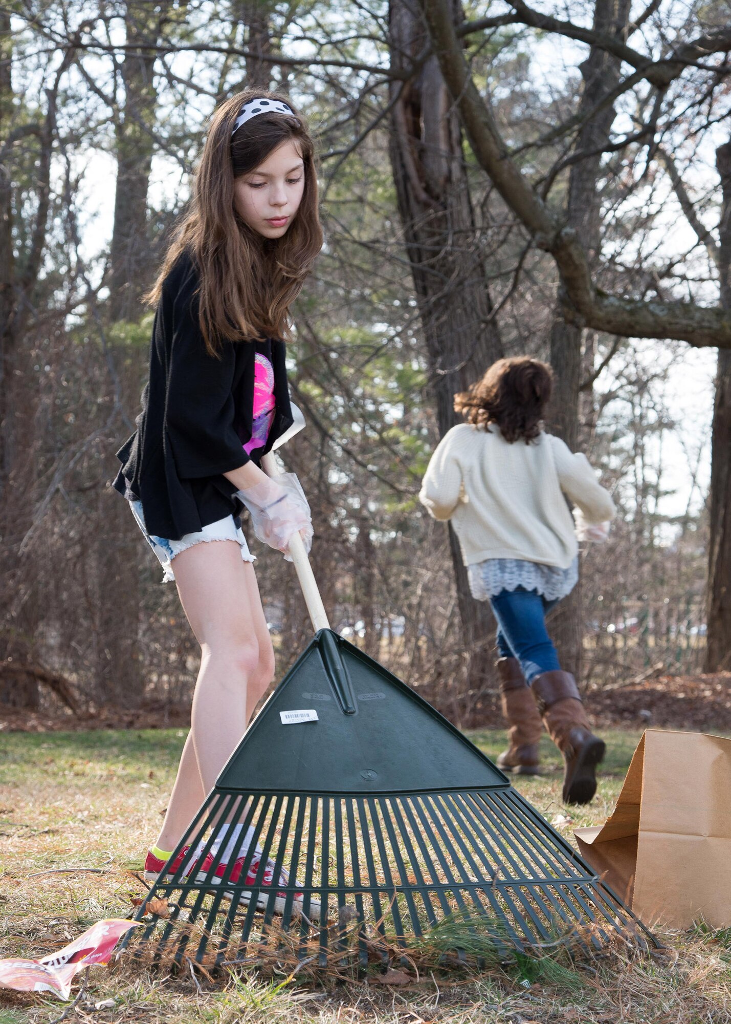 Haley Stobaugh performs community service work outside the Youth Center as part of a clean up effort March 9. The event was part of National Boys and Girls Club Week. The Youth Center is participating in the weeklong event along with nearly 4,000 other Boys and Girls Clubs throughout the United States, its territories and U.S. military installations around the world as a way to encourage children to learn more about their local club. (U.S. Air Force photo by Mark Herlihy)