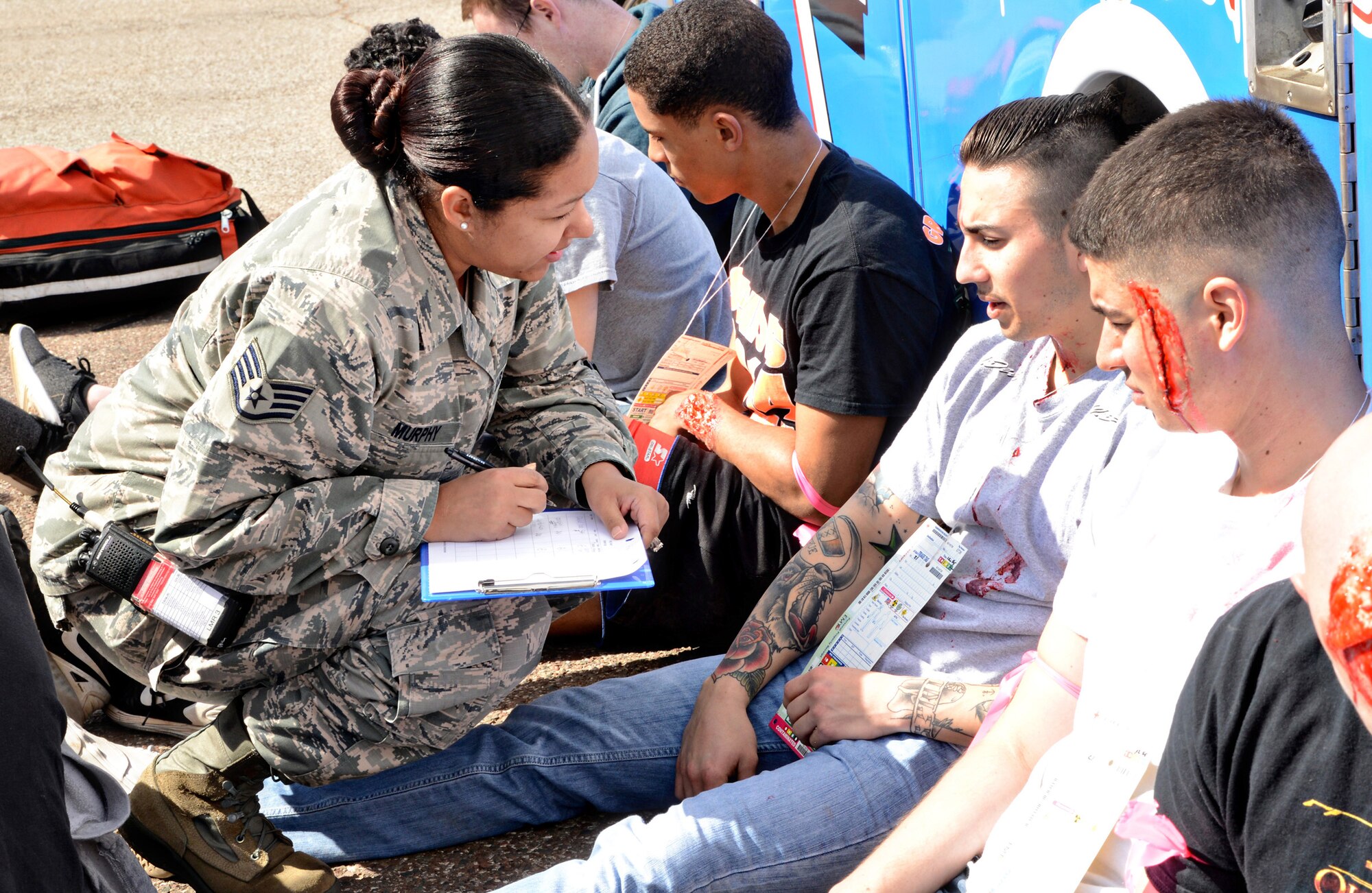 Staff Sgt. Kierstin Murphy, with the 72nd Medical Support Squadron, performs medical assessments on injured victims during the March 1 base-wide tornado exercise. (Air Force photo by Kelly White/Released)