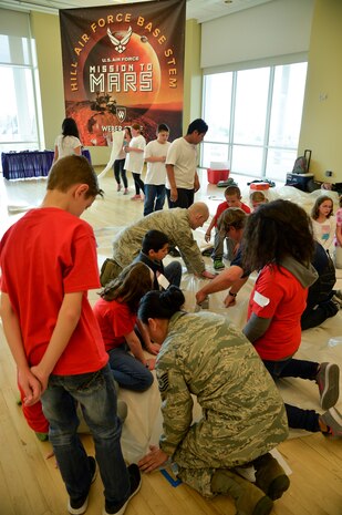 Team Hill Airmen assist students during the habitat construction portion of the ‘Mission to Mars’ STEM event at Weber State University, Ogden, Utah, March 9, 2016. (U.S. Air Force photo by R. Nial Bradshaw)