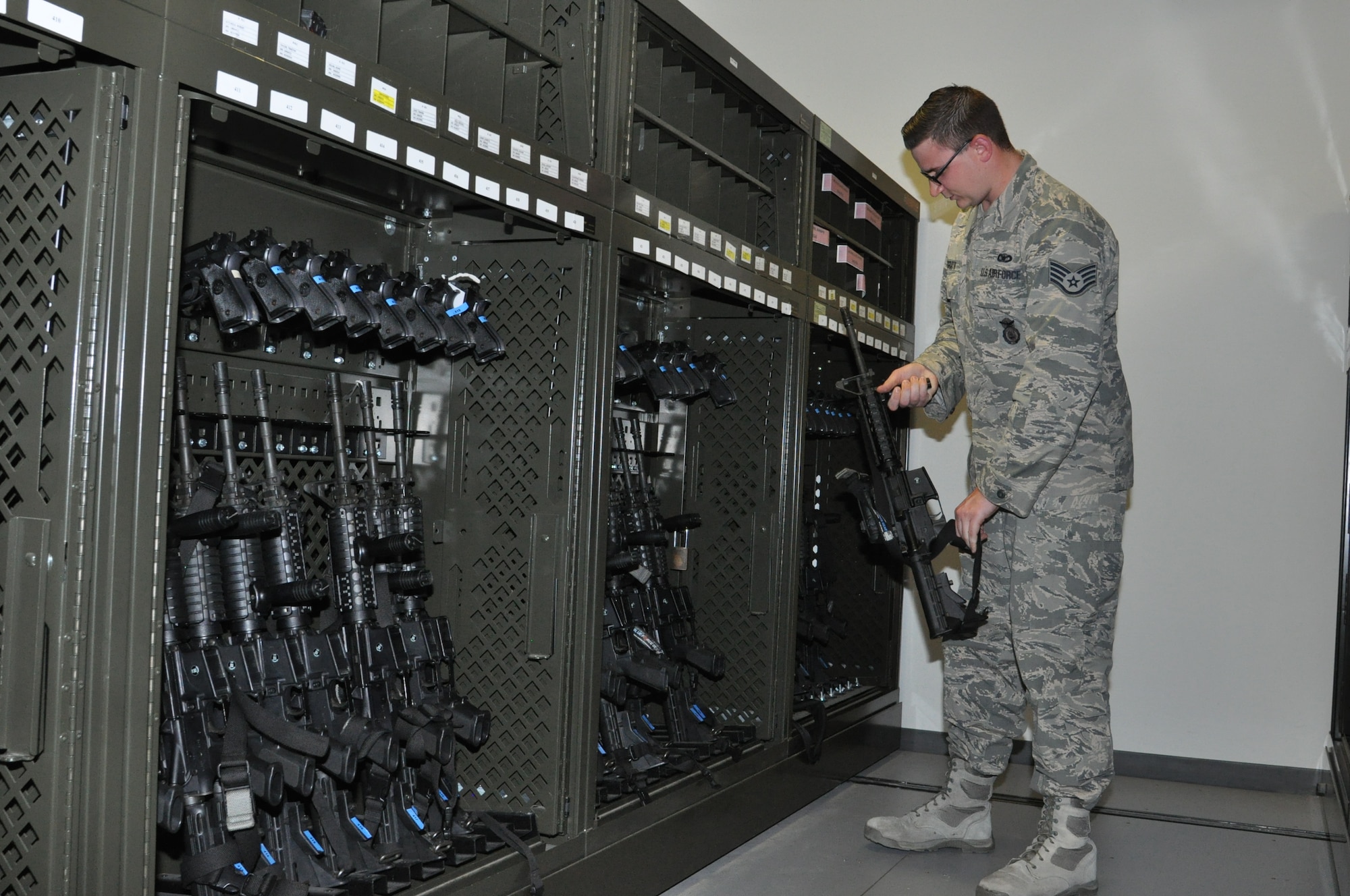 Staff Sgt. James McGrath, Armory NCOIC, stores an M-4 Carbine at the armory. (U.S. Air Force photo/Bryan Ripple.)