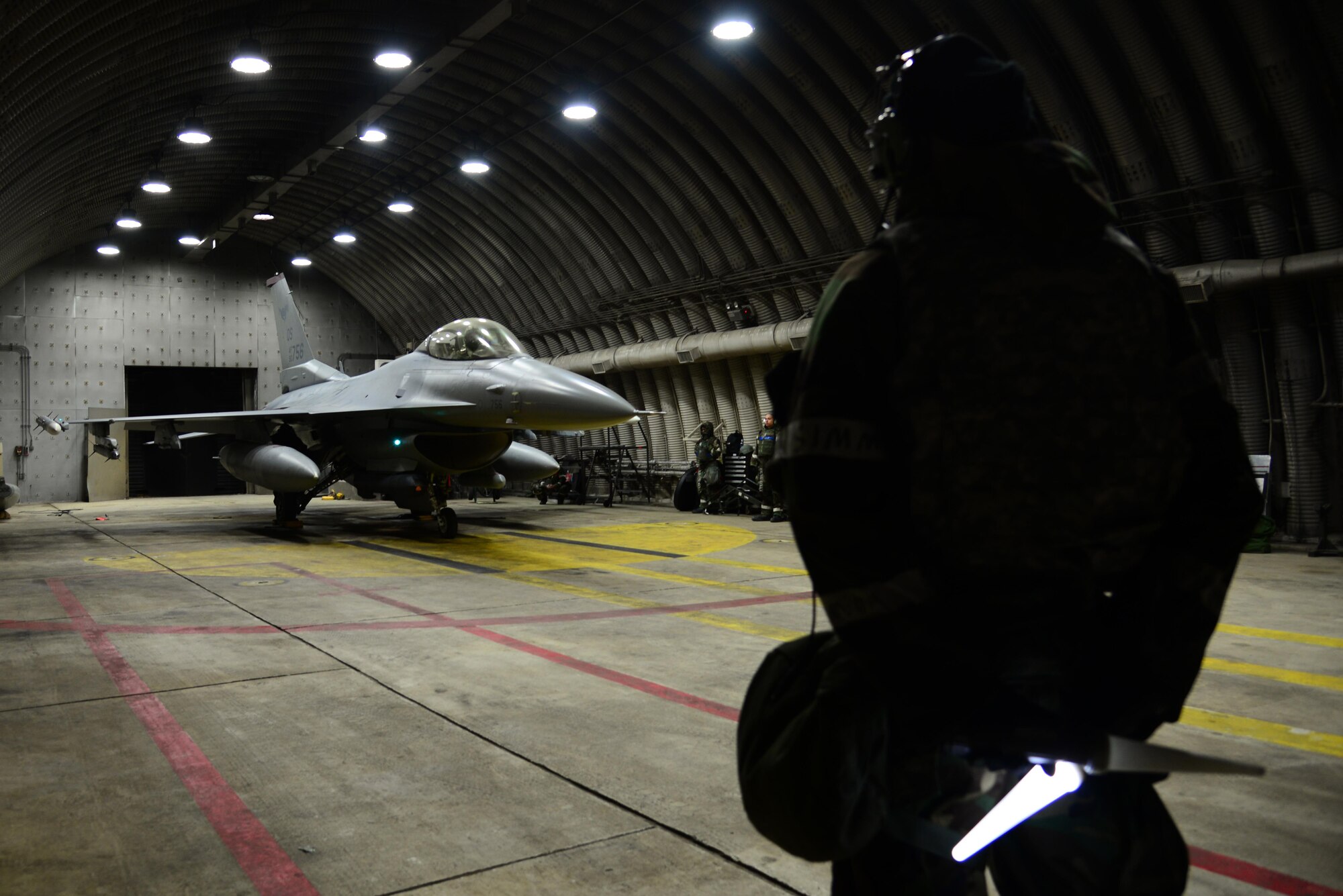 A crew chief prepares to taxi an F-16 Fighting Falcon for one of the first simulated combat sorties of exercise Beverly Midnight 16-01 at Osan Air Base, Republic of Korea, March 9, 2016. The week-long exercise is designed to test Osan Airmen’s ability during a heightened state of readiness while providing combat ready forces for close air support, air strike control, forward air control-airborne, combat search and rescue, counter air and fire, and interdiction in the defense of the ROK. (U.S. Air Force photo by Staff Sgt. Rachelle Coleman/Released) 
