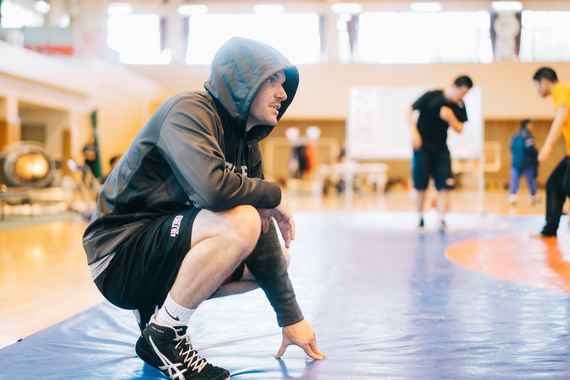 1st Lt. Randy Pence, 374th Mission Support Group executive officer, left, warms up before the start of the Japan Ground Self-Defense Force All Japan Masters Wrestling Games competitor, March 5, 2016, at Camp Asaka, Japan. The annual tournament invited competitors from throughout JSDF and U.S. military instillations in Japan to participate. (U.S. Air Force photo by Airman 1st Class Delano Scott/Released)