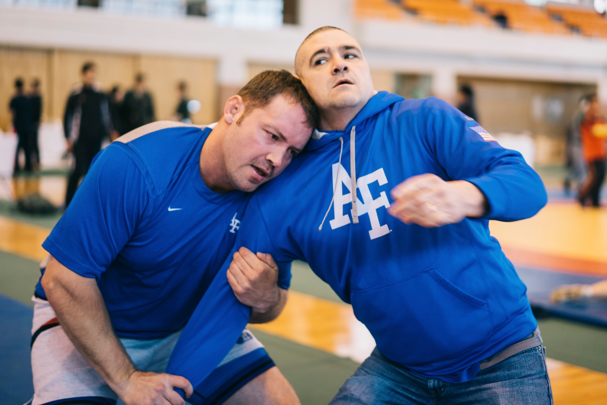 Capt. Steve Larson, 374th Operations Support Squadron current operations officer, left, practices wrestling techniques with Lt. Col. James Cunningham, 374th Comptroller Squadron commander, before the start of the Japan Ground Self-Defense Force All Japan Masters Wrestling Games, March 5, 2016, at Camp Asaka, Japan. Cunningham and Larson, coaches of the Yokota High School wrestling team, utilized the event to practice what they preached to their athletes and rekindle their competitive spirit. (U.S. Air Force photo by Airman 1st Class Delano Scott/Released)
