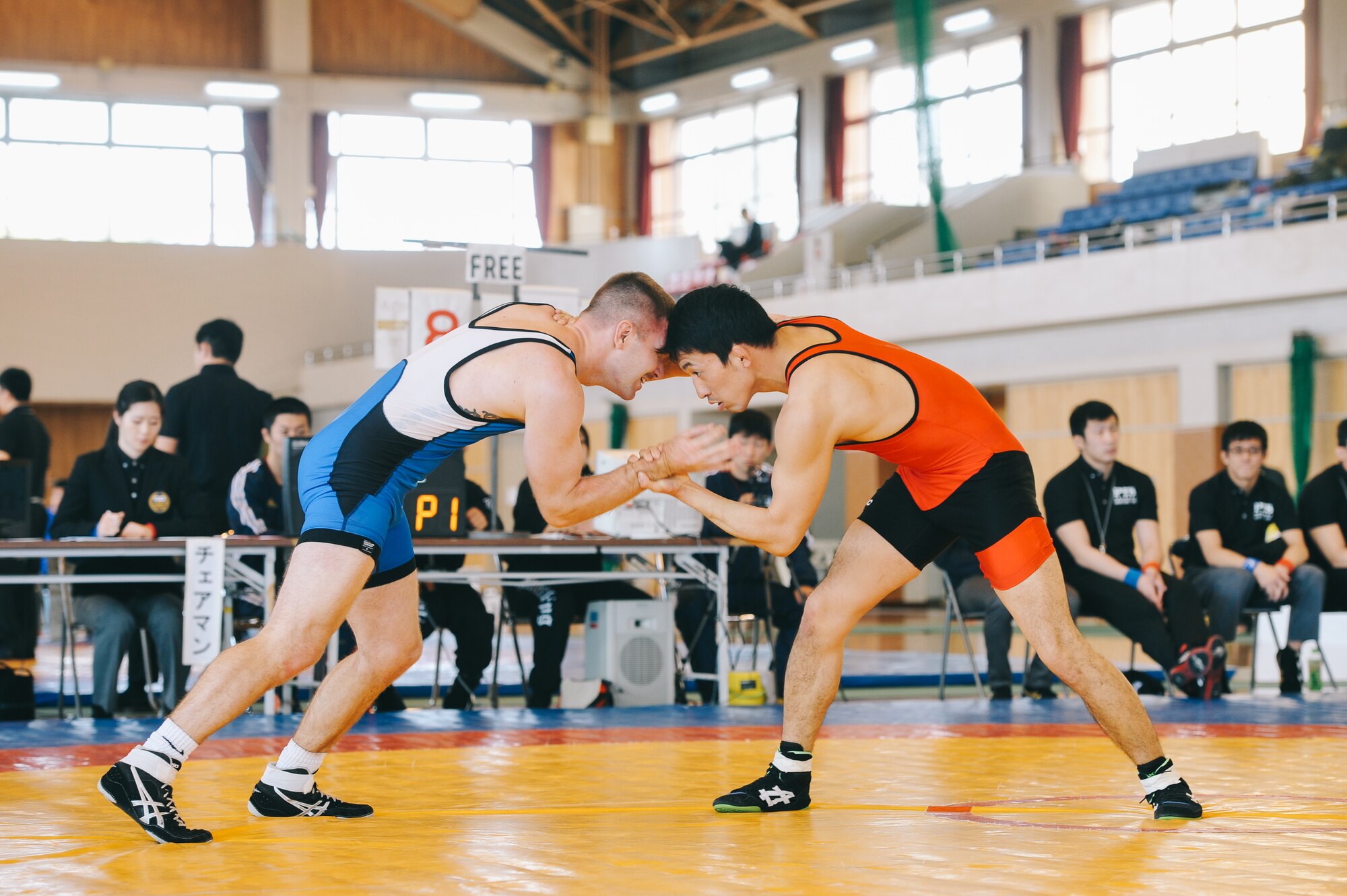 1st Lt. Randy Pence, 374th Mission Support Group executive officer, left, wrestles a Japan Ground Self-Defense Force All Japan Masters Wrestling Games competitor, March 5, 2016, at Camp Asaka, Japan. The tournament offered a chance for Yokota Airman to not only compete against their Japan partners in wrestling, but also build new friendships in the process. (U.S. Air Force photo by Airman 1st Class Delano Scott/Released)