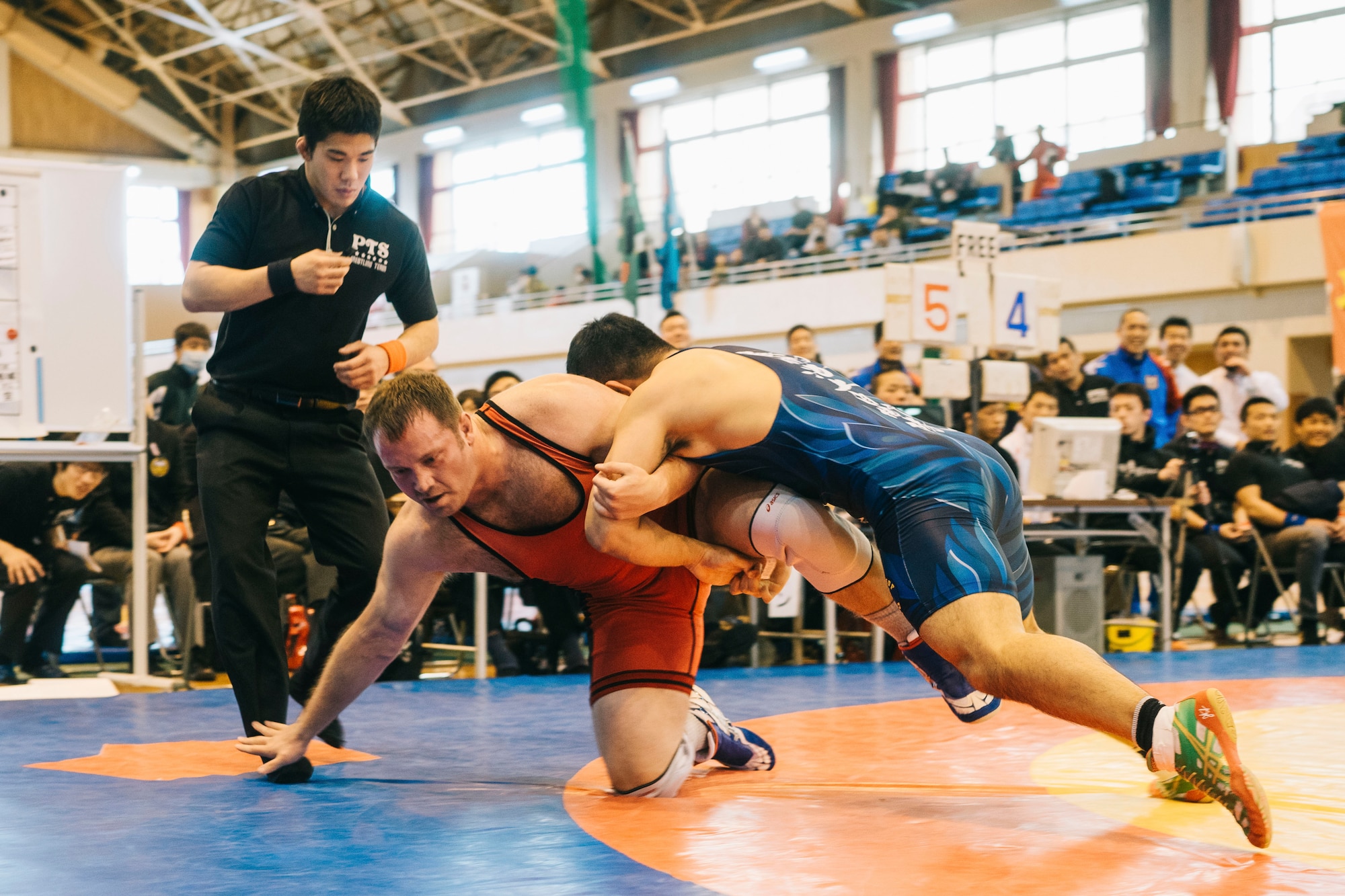 Capt. Steve Larson, 374th Operations Support Squadron current operations officer, wrestles a Japan Ground Self-Defense Force All Japan Masters Wrestling Games competitor, March 5, 2016, at Camp Asaka, Japan. . The two-day event featured double elimination individual and single elimination team tournaments. (U.S. Air Force photo by Airman 1st Class Delano Scott/Released)
