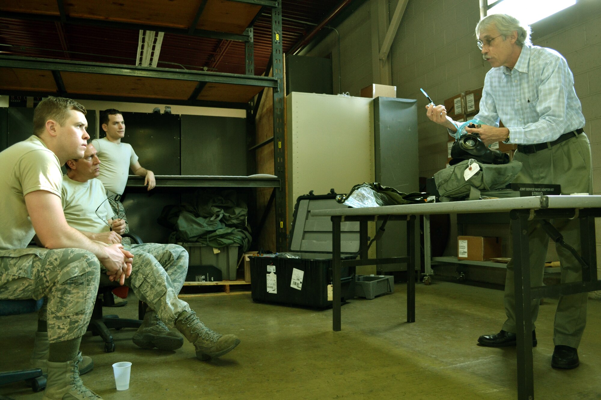 From left to right, Senior Airman Igor Karlov, Tech. Sgt. Robert Custer and Staff Sgt. Heikell Perez, all members of the 111th Logistics Readiness Squadron in the 111th Attack Wing, recieve customized training from  John Patchan, the Joint Program Executive Office-Chemical, Biological Defense Enterprise Fielding and Surveillance team leader for Team Tyndall, at Horsham Air Guard Station. Pa., March  10, 2016. The team was brought in to assist in completing M-50 Joint Service General Purpose Mask fit test assurance for the 111th Attack Wing to remain compliant. Sponsored by the National Guard Bureau, they saved the unit approximately $6,200.00 and tested an estimated 750 masks within a two-week timeframe. (U.S. Air National Guard photo by Tech. Sgt. Andria Allmond)
