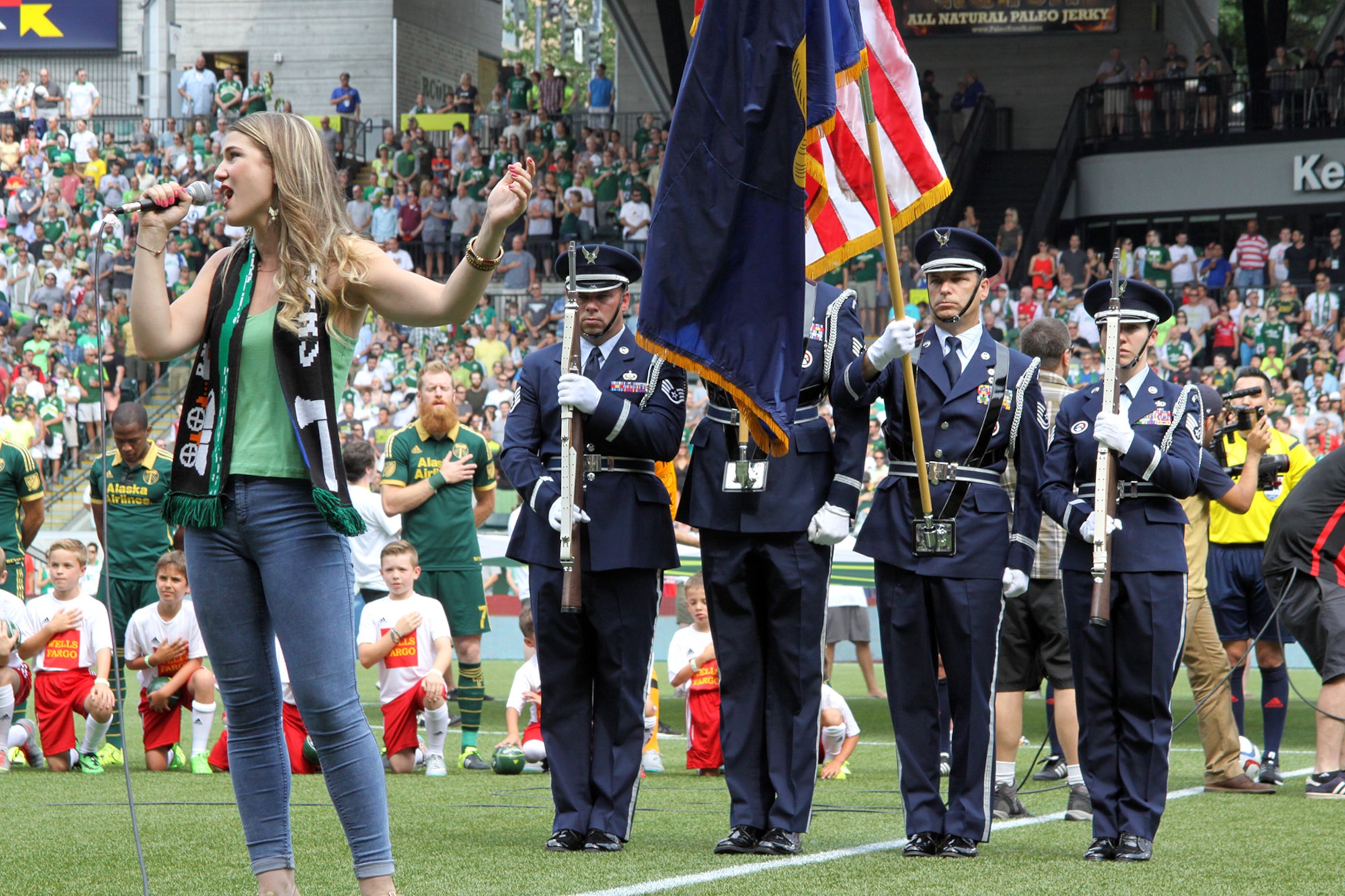 Members of the Portland Air National Guard Base Honor Guard team present the colors during the National Anthem sung by Madison Shanley, prior to the kickoff match between the Portland Timbers and Seattle Sounds, at Providence Park, Portland, Ore., June 28, 2015. (U.S. Air National Guard photo by Master Sgt. Shelly Davison, 142nd Fighter Wing Public Affairs/Released)