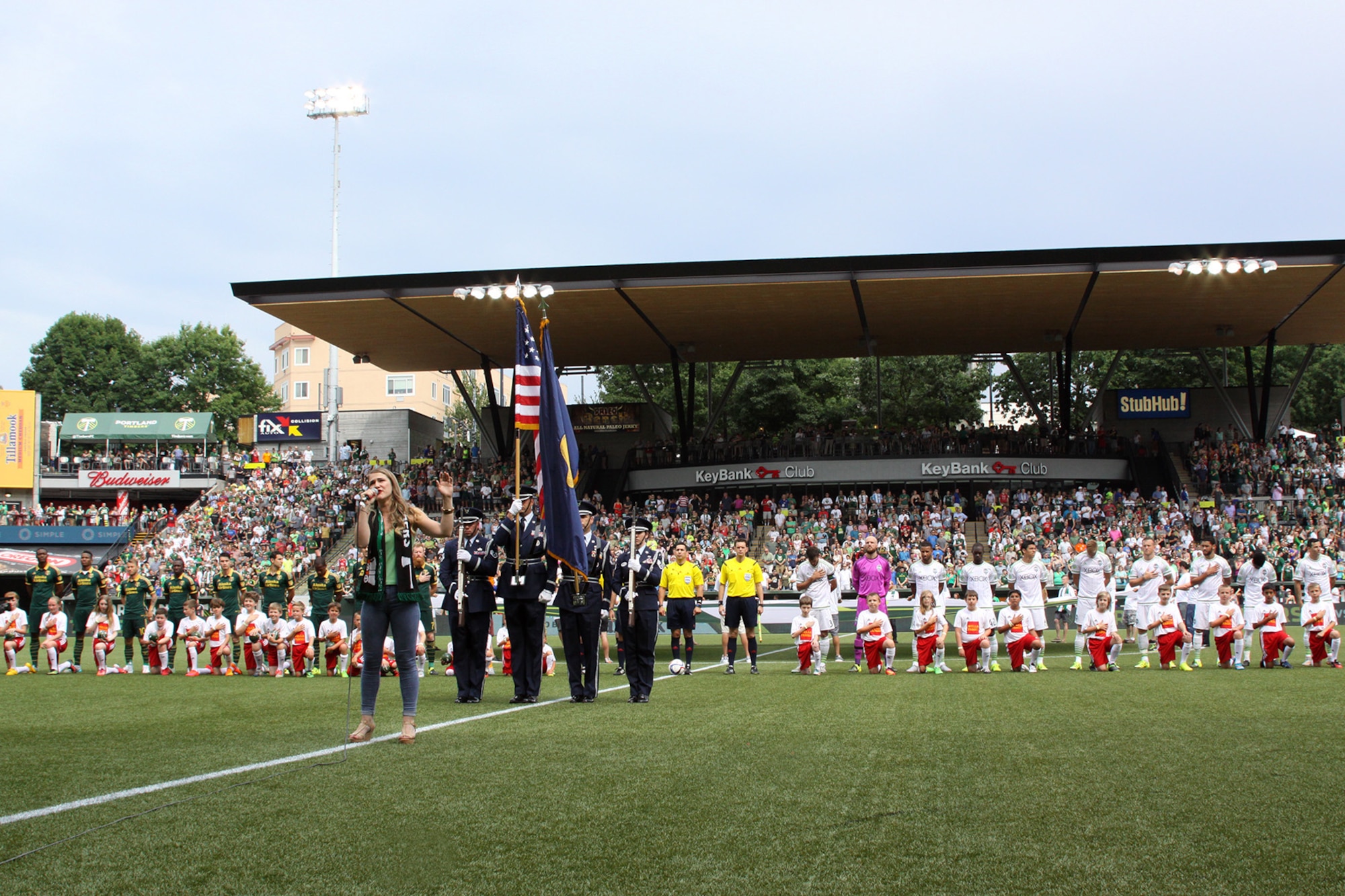 Members of the Portland Air National Guard Base Honor Guard team present the colors during the National Anthem sung by Madison Shanley, prior to the kickoff match between the Portland Timbers and Seattle Sounds, at Providence Park, Portland, Ore., June 28, 2015. (U.S. Air National Guard photo by Master Sgt. Shelly Davison, 142nd Fighter Wing Public Affairs/Released)