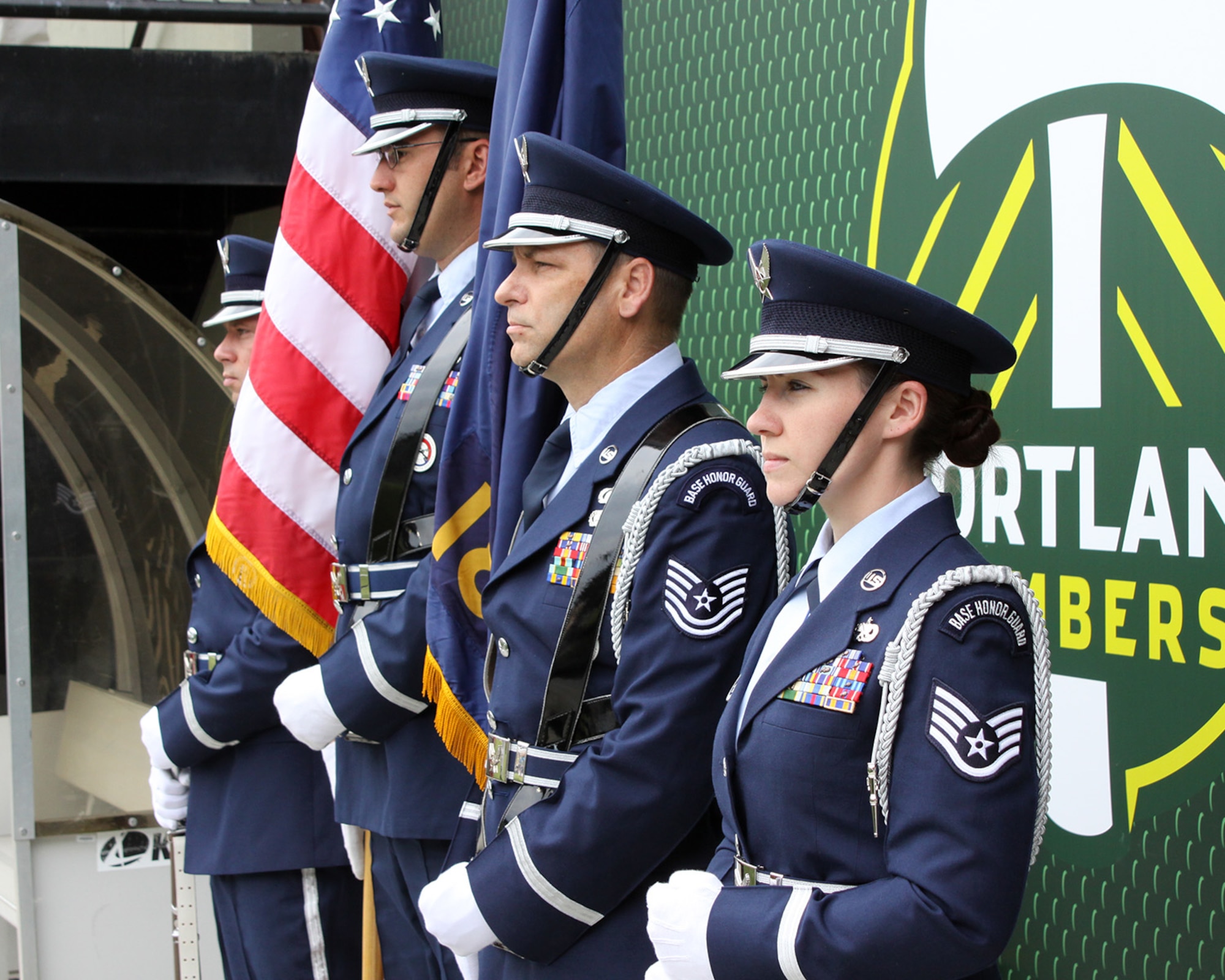 Members of the Portland Air National Guard Base Honor Guard team, from left to right, Staff Sgt. Joseph Regas, Staff Sgt. Bret Workman, Tech. Sgt. John Hughel, and Staff Sgt. Kalene Kaplan wait on the sidelines at Providence Park, Portland, Ore., to Present the Colors at the Portland Timbers soccer match against the Seattle Sounders, June 28, 2015. (U.S. Air National Guard photo by Master Sgt. Shelly Davison, 142nd Fighter Wing Public Affairs/Released)
