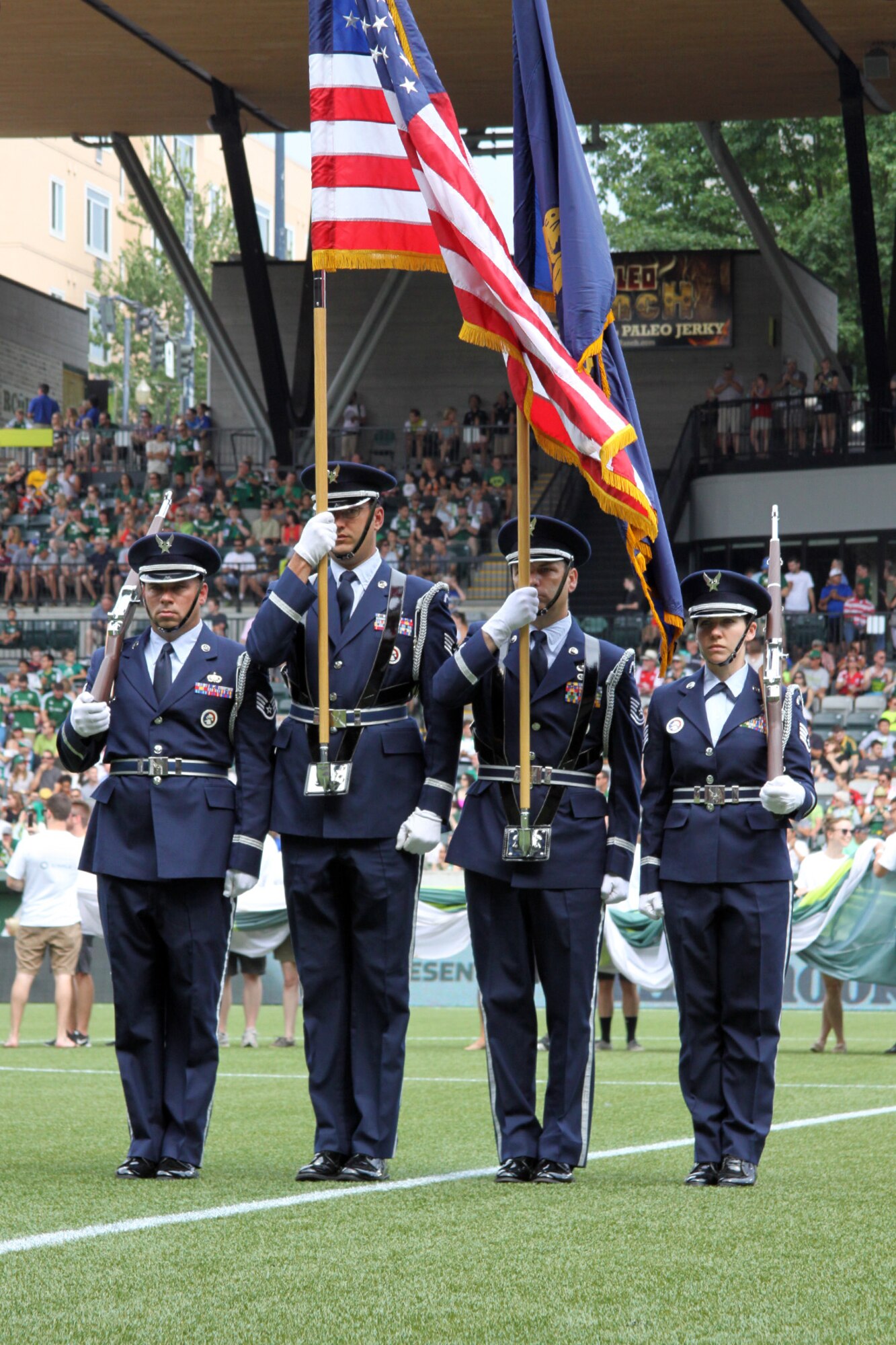 Members of the Portland Air National Guard Base Honor Guard team, from left to right, Staff Sgt. Joseph Regas, Staff Sgt. Bret Workman, Tech. Sgt. John Hughel, and Staff Sgt. Kalene Kaplan Present the Colors at the Portland Timbers soccer match against the Seattle Sounders held at Providence Park, Portland, Ore., June 28, 2015. (U.S. Air National Guard photo by Master Sgt. Shelly Davison, 142nd Fighter Wing Public Affairs/Released)