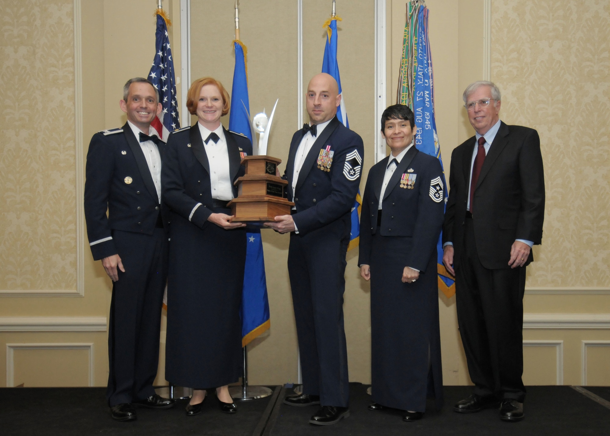 The 310th Space Wing celebrates its eighteenth annual awards banquet at the Antlers Hotel in Colorado Springs, Colo., March 4, 2016. The 310th Space Wing Commander, Command Chief and U.S. Air Force General (Ret.) Robert H. “Doc” Fogelsong pose for a winning photo with the 710th Security Forces Chief and Commander. The wing sponsored the event to both recognize its annual award winners and bring Reservists together to enjoy an evening of esprit de corps, unit morale and camaraderie. (U.S. Air Force photo/Tech. Sgt. Sarah Corrice) 