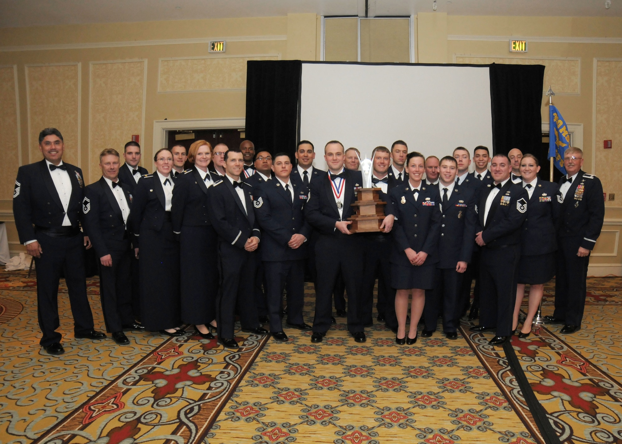 The 310th Space Wing celebrates its eighteenth annual awards banquet at the Antlers Hotel in Colorado Springs, Colo., March 4, 2016. Unit of the Year, The 710th Security Forces Squadron who won the Unit of the Year award poses with the trophy. The wing sponsored the event to both recognize its annual award winners and bring Reservists together to enjoy an evening of esprit de corps, unit morale and camaraderie. (U.S. Air Force photo/Tech. Sgt. Sarah Corrice) 