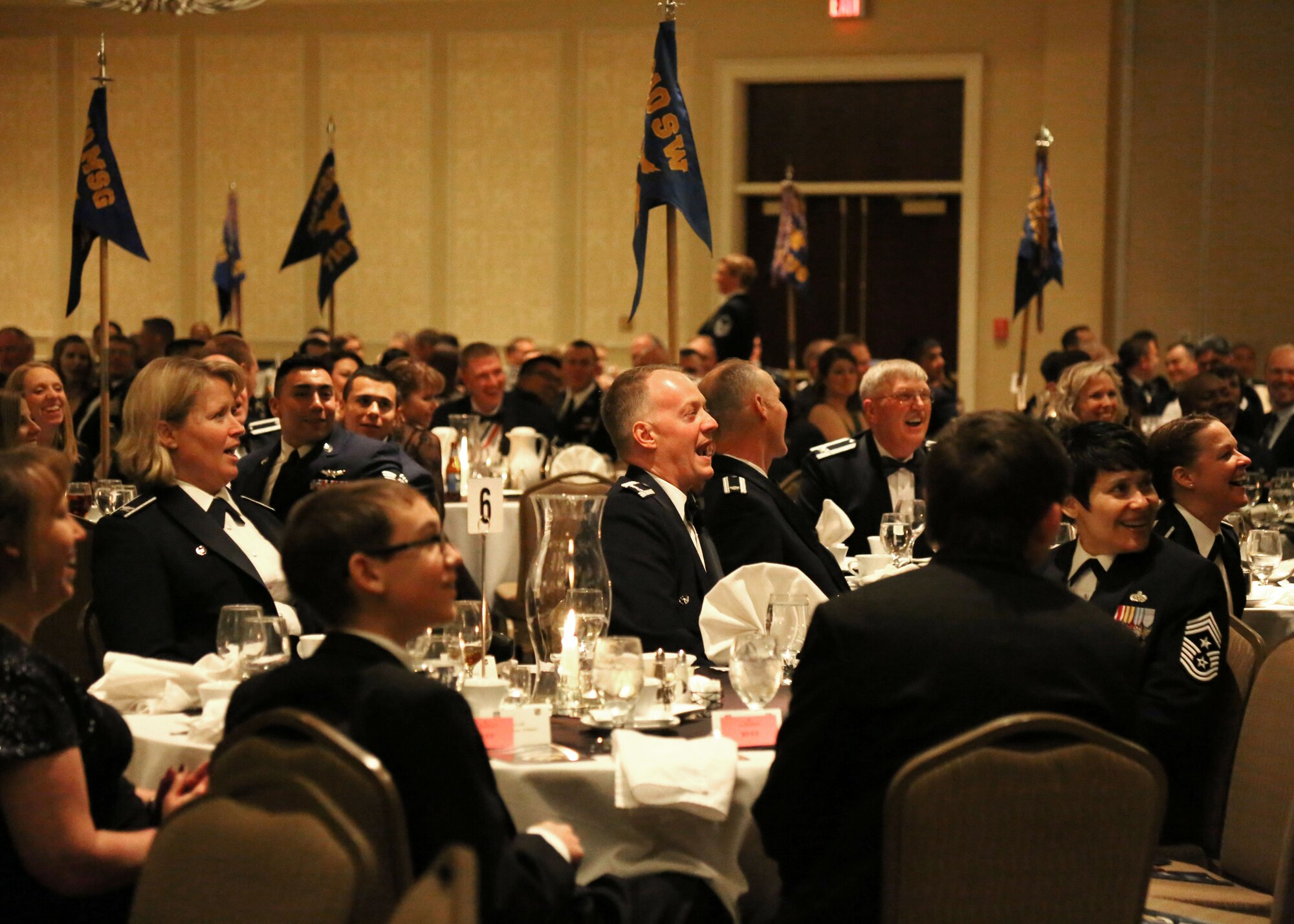 The 310th Space Wing celebrates its eighteenth annual awards banquet at the Antlers Hotel in Colorado Springs, Colo., March 4, 2016. The 50th Space Wing Commander Col. DeAnna M. Burt and Colonel Robert Claude the Vice Commander enjoy a presentation by the  310th Space Wing Commander, The wing sponsored the event to both recognize its annual award winners and bring Reservists together to enjoy an evening of esprit de corps, unit morale and camaraderie. (U.S. Air Force photo/Tech. Sgt. Sarah Corrice) 