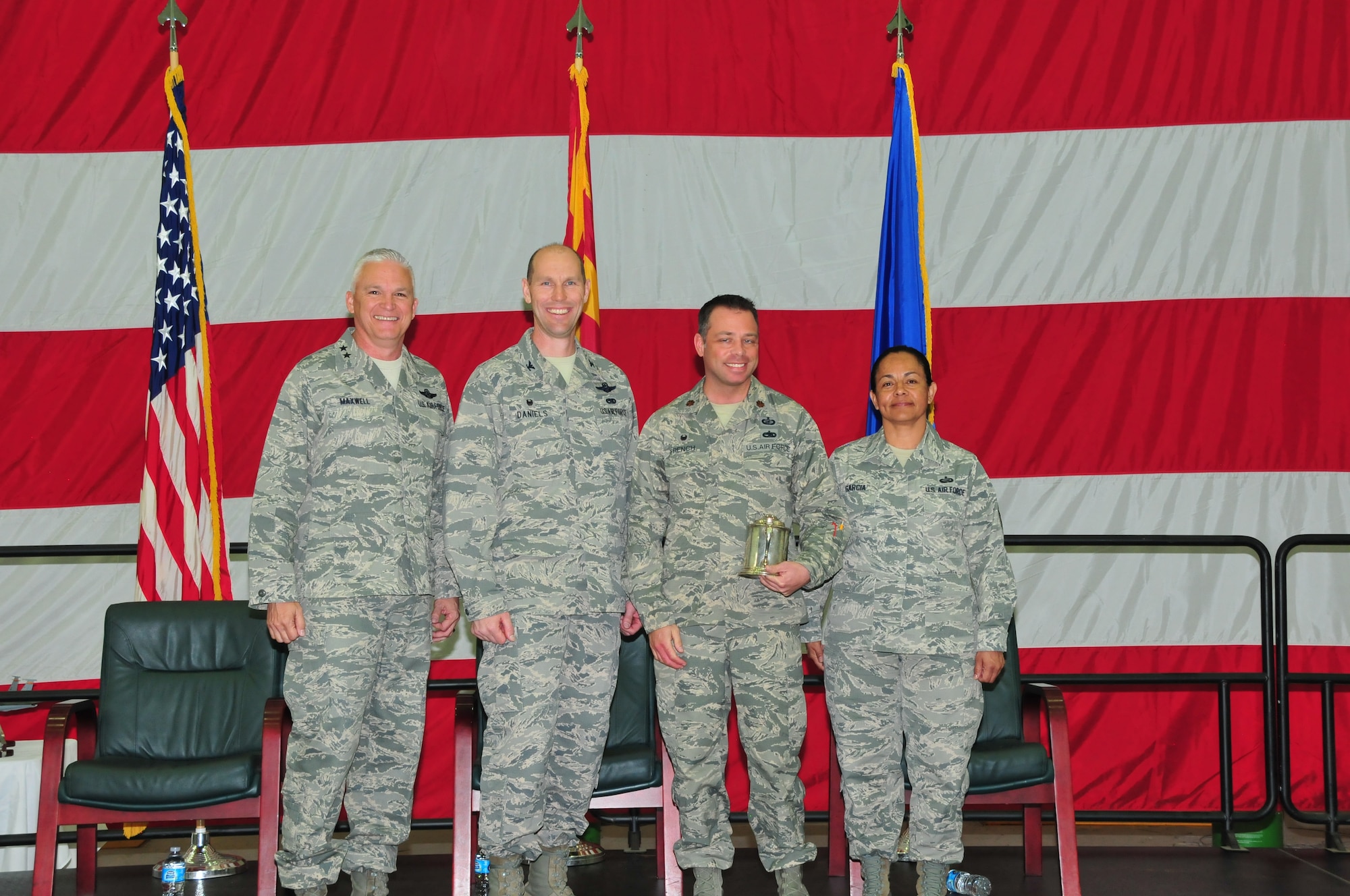 Maj. Joshua French was awarded the Albert Leo Burns award at the 161st Air Refueling Wing annual awards ceremony March 6, 2016, Phoenix Sky Harbor Air National Guard Base. From left to right: Maj. Gen. Edward Maxwell, Arizona Air National Guard commander, Col. Troy Daniels, 161st Air Refueling Wing commander, Maj. Joshua French and Chief Master Sgt. Martha Garcia, 161st Air Refueling Wing command chief. (U. S. Air National Guard photo by Master Sgt. Kelly M. Deitloff/Released)