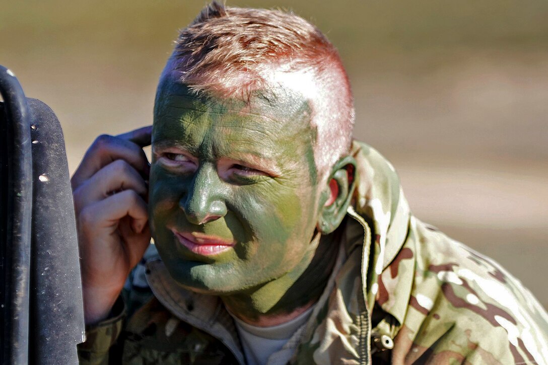 Army Capt. Andy Jenks paints his face in camoflauge during Exercise Sky Soldier 16 at Chinchilla training area in Albacete, Spain, March 4, 2016. Jenks is assigned to the 1st Battalion, 503rd Infantry Regiment, 173rd Airborne Brigade. Army photo by Staff Sgt. Opal Vaughn