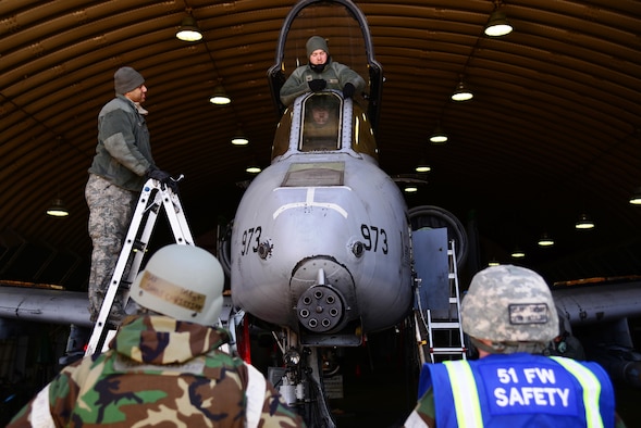 From left, Master Sgt. Shane Christian, 51st Fighter Wing occupational safety manager, and Senior Master Sgt. Sean Rouillier, 51st FW superintendent of safety, speak with Airmen assigned to the 25th Aircraft Maintenance Unit, March 10, 2016, at Osan Air Base, Republic of Korea. Airmen are performing standard maintenance along with participating in Exercise Beverly Midnight 16-01. Members of the wing safety office pull double-duty, ensuring both exercise participants and non-players are following the required safety standards. (U.S. Air Force photo by Staff Sgt. Benjamin Sutton/Released)