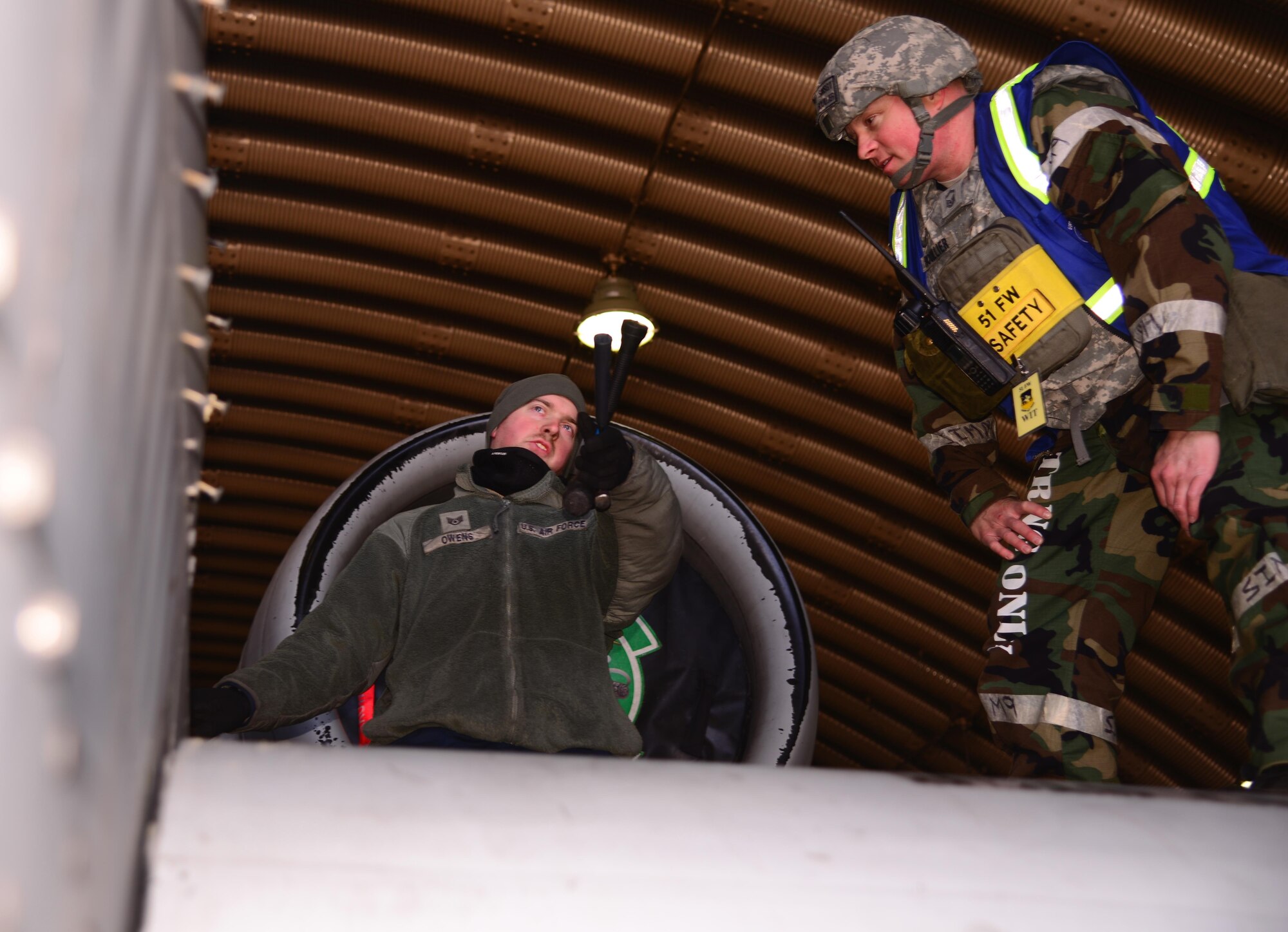 Staff Sgt. Zachary Owens, 25th Aircraft Maintenance Unit electrical environmental craftsman, speaks with Senior Master Sgt. Sean Rouillier, 51st Fighter Wing superintendent of safety, March 10, 2016, at Osan Air Base, Republic of Korea. Occupational safety members are responsible for educating, inspecting and advising Airmen on risk mitigation strategies during both normal and exercise operations like Beverly Midnight 16-01. (U.S. Air Force photo by Staff Sgt. Benjamin Sutton/Released)