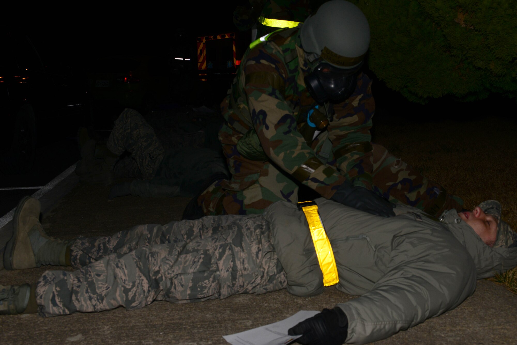 The 8th Medical Group decontamination team assess patients before starting an in place patient decon during the Beverly Midnight 16-1 exercise Mar. 9, 2016. The team performed a decon on six individuals before taking them in as patients during the exercise. (U.S. Air Force photo by Senior Airman Ashley L. Gardner/ Released)