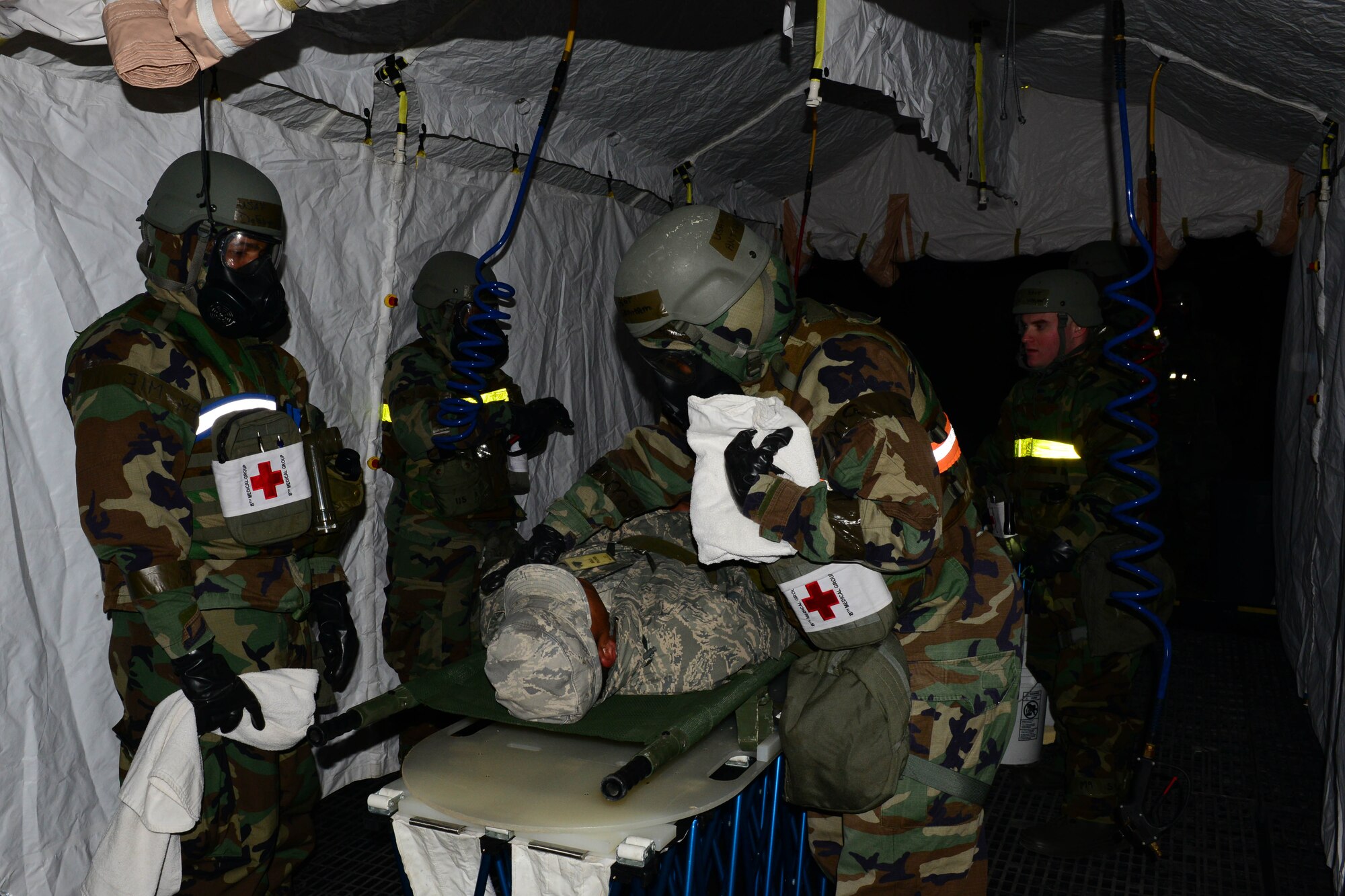 The 8th Medical Group decontamination team perform an in-place patient decon during the Beverly Midnight 16-1 exercise Mar. 9, 2016. The team performed a decon on six individuals before taking them in as patients during the exercise. (U.S. Air Force photo by Senior Airman Ashley L. Gardner/ Released)