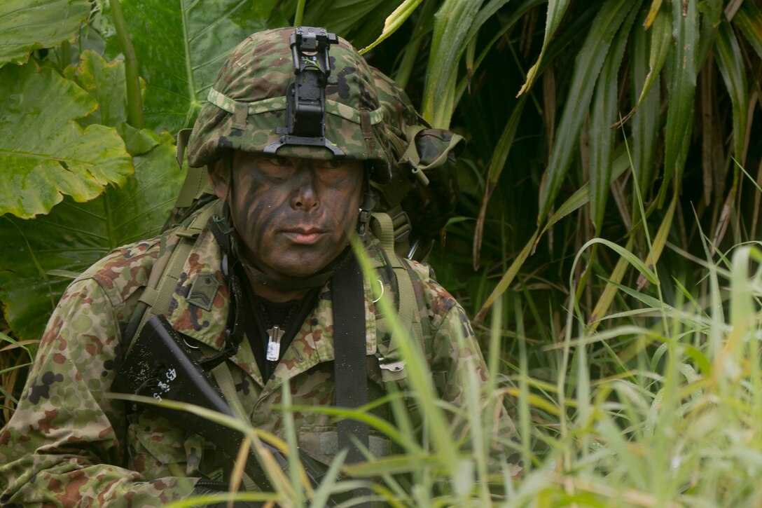 A member of the Japan Ground Self-Defense Force acts as security during a raid mission at Kin Blue, Okinawa Japan, Mar. 11. The intent of the mission was to stop a mock smuggling organization. The JGSDF members incorporated a variety of techniques they observed from 3rd Reconnaissance Battalion, 3rd Marine Division, III Marine Expeditionary Force. The techniques include scout swimming, nautical navigation, beach securing, and reconnaissance. The members are with the 43rd Infantry Regiment.