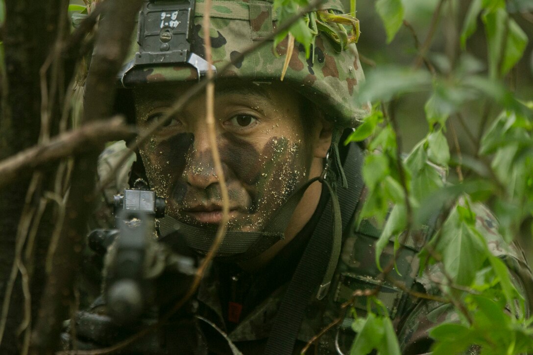 A member of the Japan Ground Self-Defense Force acts as security during a raid mission at Kin Blue, Okinawa Japan, Mar. 11. The intent of the mission was to stop a mock smuggling organization. The JGSDF members incorporated a variety of techniques they observed from 3rd Reconnaissance Battalion, 3rd Marine Division, III Marine Expeditionary Force. The techniques include scout swimming, nautical navigation, beach securing, and reconnaissance. The members are with the 43rd Infantry Regiment.