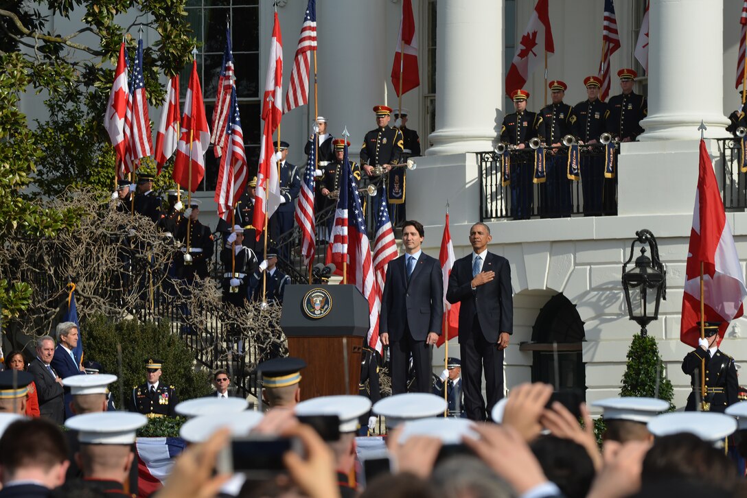 President Barack Obama, right, and Canadian Prime Minister Justin Trudeau render honors during the playing of their national anthems as U.S. troops participate during an official visit at the White House, March 10, 2016. Air National Guard photo by Staff Sgt. Christopher S. Muncy