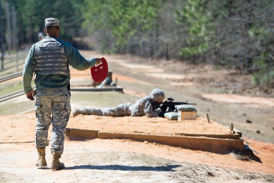 A soldier, left, waits to signal the all clear to range safety at the qualification range on Fort Jackson, S.C. Feb. 27, 2016. South Carolina Air National Guard photo by Tech. Sgt. Jorge Intriago
