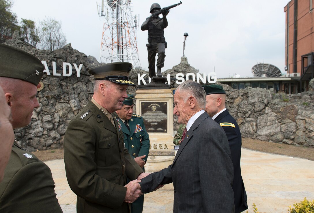 Marine Corps Gen. Joseph F. Dunford Jr., chairman of the Joint Chiefs of Staff, greets a Colombian Korean War veteran at the Korean War Memorial in Bogota, Colombia, March 10, 2016. DoD photo by Navy Petty Officer 2nd Class Dominique A. Pineiro