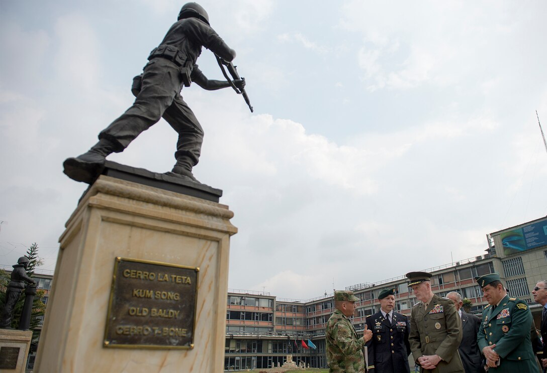 Marine Corps Gen. Joseph F. Dunford Jr., chairman of the Joint Chiefs of Staff, second from right, listens to a brief about Colombia's involvement in the Korean War while visiting the Korean War Memorial in Bogota, Colombia, March 10, 2016. DoD photo by Navy Petty Officer 2nd Class Dominique A. Pineiro