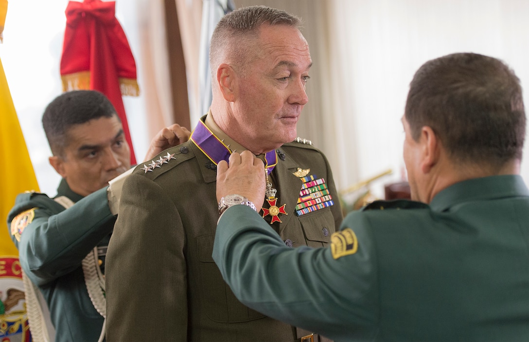 Gen. Juan Pablo Rodriguez, commander of Colombia's armed forces,  right, presents the Fe en la Causa medal to Marine Corps Gen. Joseph F. Dunford Jr., chairman of the Joint Chiefs of Staff, for his support of Colombian military efforts in Bogota, Colombia, March 10, 2016. DoD photo by Navy Petty Officer 2nd Class Dominique A. Pineiro
