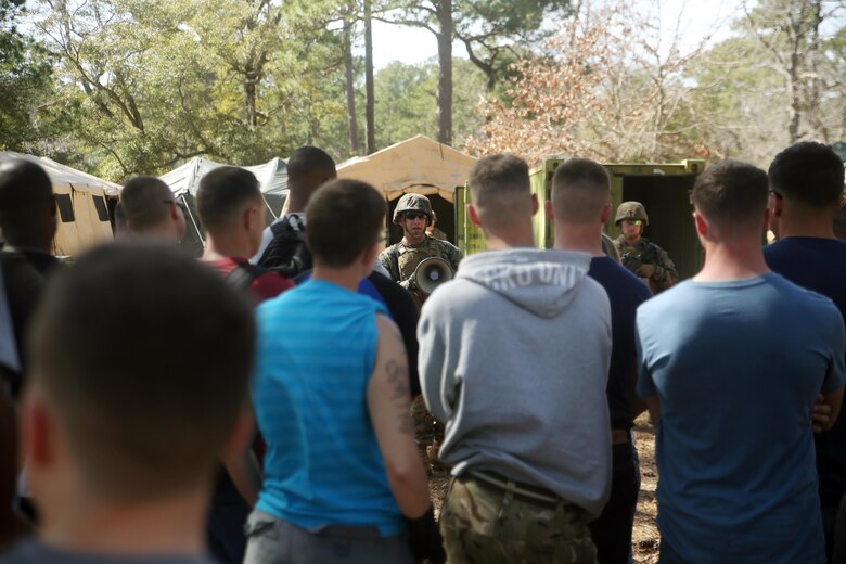 Sgt. Brandyn Knight, the Evacuation Control Center entry point noncommissioned officer in charge with Combat Logistics Battalion 2, briefs notionally displaced American citizens as they prepare to enter the ECC to be evacuated during the battalion’s certification exercise, at Marine Corps Auxiliary Landing Field Bogue, N.C., March 10, 2016. The battalion is slated to deploy on Special Purpose Marine Air-Ground Task Force-Crisis Response-Africa later this year. (U.S. Marine Corps photo by Cpl. Joey Mendez)