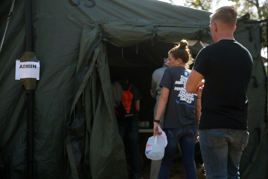 Notionally-displaced American citizens with Combat Logistics Battalion 2 wait in line to complete their check-in process at the Evacuation Control Center during the battalion’s certification exercise, at Marine Corps Auxiliary Landing Field Bogue, N.C., March 10, 2016. The battalion is slated to deploy on Special Purpose Marine Air-Ground Task Force-Crisis Response-Africa later this year. (U.S. Marine Corps photo by Cpl. Joey Mendez)