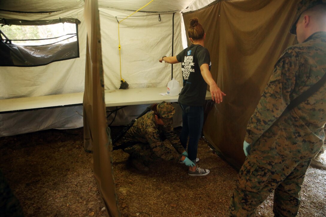 A notionally-displaced American citizen is searched by a Marine with Combat Logistics Battalion 2 at the Evacuation Control Center during the battalion’s certification exercise, at Marine Corps Auxiliary Landing Field Bogue, N.C., March 10, 2016. The battalion is slated to deploy on Special Purpose Marine Air-Ground Task Force-Crisis Response-Africa later this year. (U.S. Marine Corps photo by Cpl. Joey Mendez)