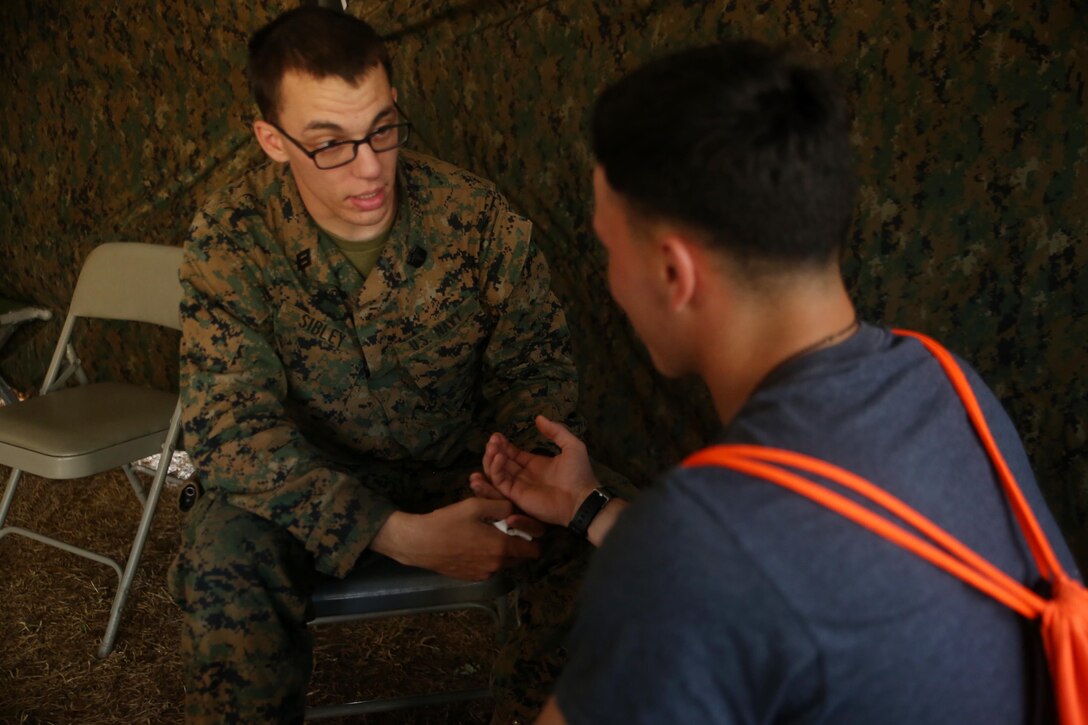 U.S. Navy Seaman Andrew Sibley, a hospitalman with Combat Logistics Battalion 2 treats a role player as he enters the Evacuation Control Center during the battalion’s certification exercise, at Marine Corps Auxiliary Landing Field Bogue, N.C., March 10, 2016. The battalion is slated to deploy on Special Purpose Marine Air-Ground Task Force-Crisis Response-Africa later this year. (U.S. Marine Corps photo by Cpl. Joey Mendez)