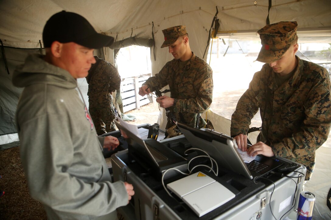 Marine landing support specialists with Combat Logistics Battalion 2 assist a notionally displaced American citizen with disembarking a hostile foreign country during the battalion’s certification exercise, at Marine Corps Auxiliary Landing Field Bogue, N.C., March 10, 2016. The battalion is slated to deploy on Special Purpose Marine Air-Ground Task Force-Crisis Response-Africa later this year. (U.S. Marine Corps photo by Cpl. Joey Mendez)