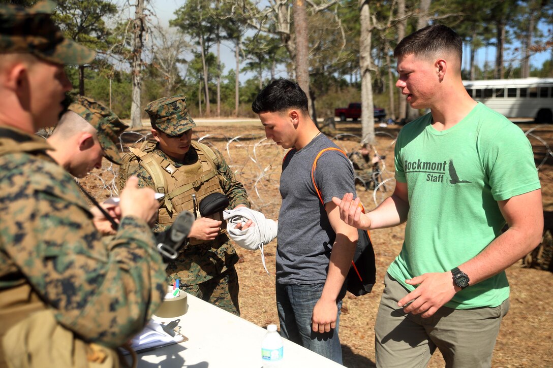 U.S. Navy Petty Officer 2nd Class James Aliviado, a hospital corpsman with Combat Logistics Battalion 2, evaluates an injury of a notionally displaced American citizen as he enters the Evacuation Control Center during the battalion’s certification exercise, at Marine Corps Auxiliary Landing Field Bogue, N.C., March 10, 2016. The battalion is slated to deploy on Special Purpose Marine Air-Ground Task Force-Crisis Response-Africa later this year. (U.S. Marine Corps photo by Cpl. Joey Mendez)