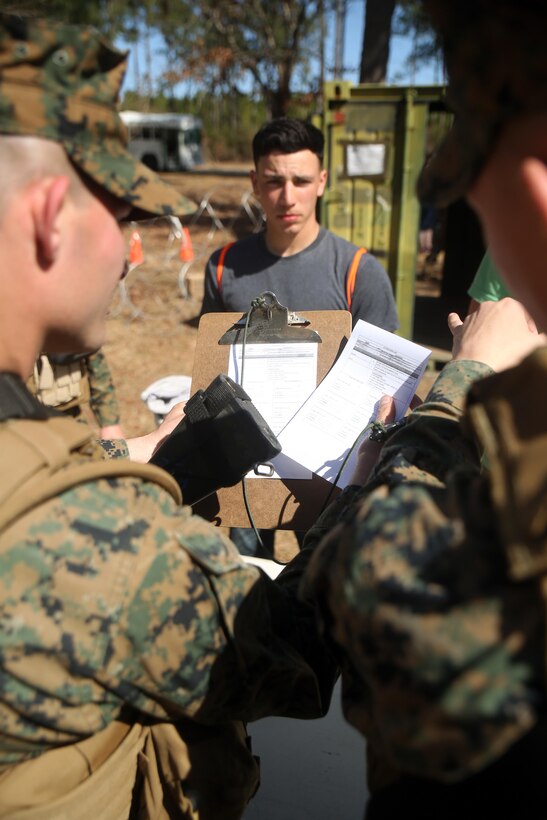 Marines with Combat Logistics Battalion 2, verify the identity of a notionally-displaced citizen at the first station of the Evacuation Control Center during the battalion’s certification exercise, at Marine Corps Auxiliary Landing Field Bogue, N.C., March 10, 2016. The battalion is slated to deploy on Special Purpose Marine Air-Ground Task Force-Crisis Response-Africa later this year. (U.S. Marine Corps photo by Cpl. Joey Mendez)