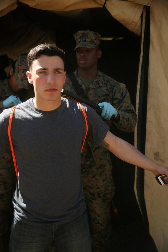 Lance Cpl. Dean Rosas, a motor vehicle operator with Combat Logistics Battalion 2, gets scanned while playing the role of a notionally-displaced citizen in need of evacuation from a foreign country in the Evacuation Control Center during the battalion’s certification exercise, at Marine Corps Auxiliary Landing Field Bogue, N.C., March 10, 2016. The battalion is slated to deploy on Special Purpose Marine Air-Ground Task Force-Crisis Response-Africa later this year. (U.S. Marine Corps photo by Cpl. Joey Mendez)